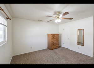 Primary room featuring carpet flooring and a ceiling fan
