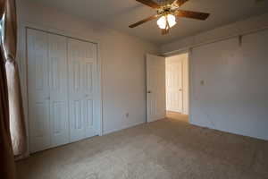 Bedroom 2 with carpet floors, a ceiling fan, and a closet