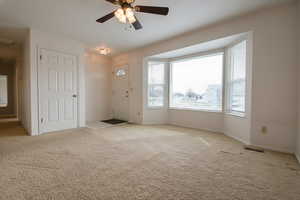 Foyer entrance featuring a ceiling fan.