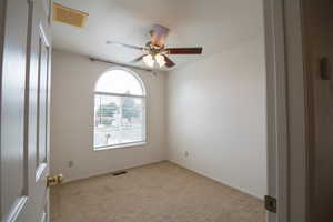 Bedroom 1 featuring light colored carpet and a ceiling fan