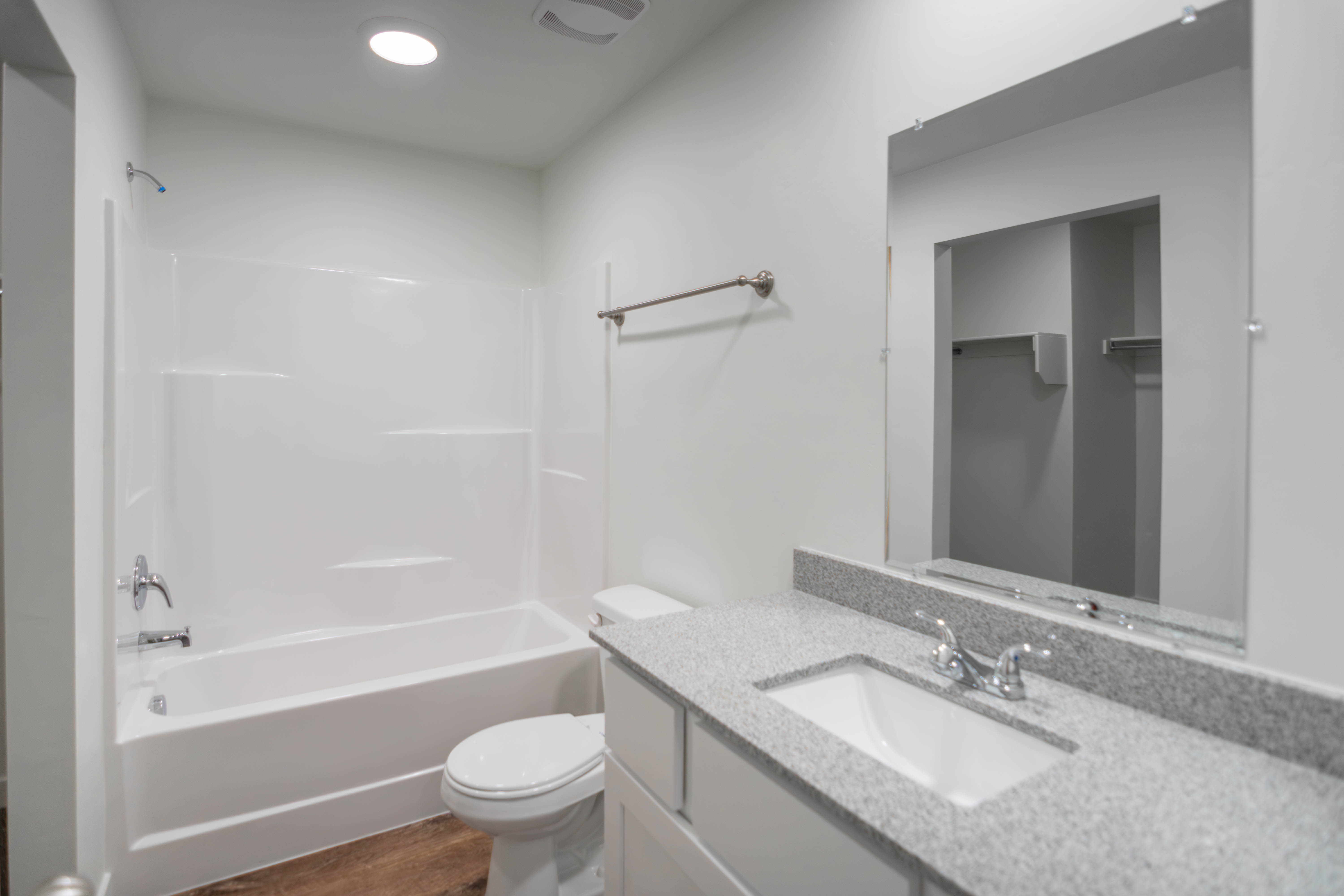 Full bathroom featuring vanity, bathing tub / shower combination, and dark wood-style floors