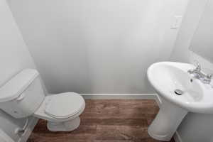 Bathroom with dark wood-style floors and baseboards