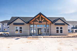 View of front of home featuring a porch, board and batten siding, and a shingled roof