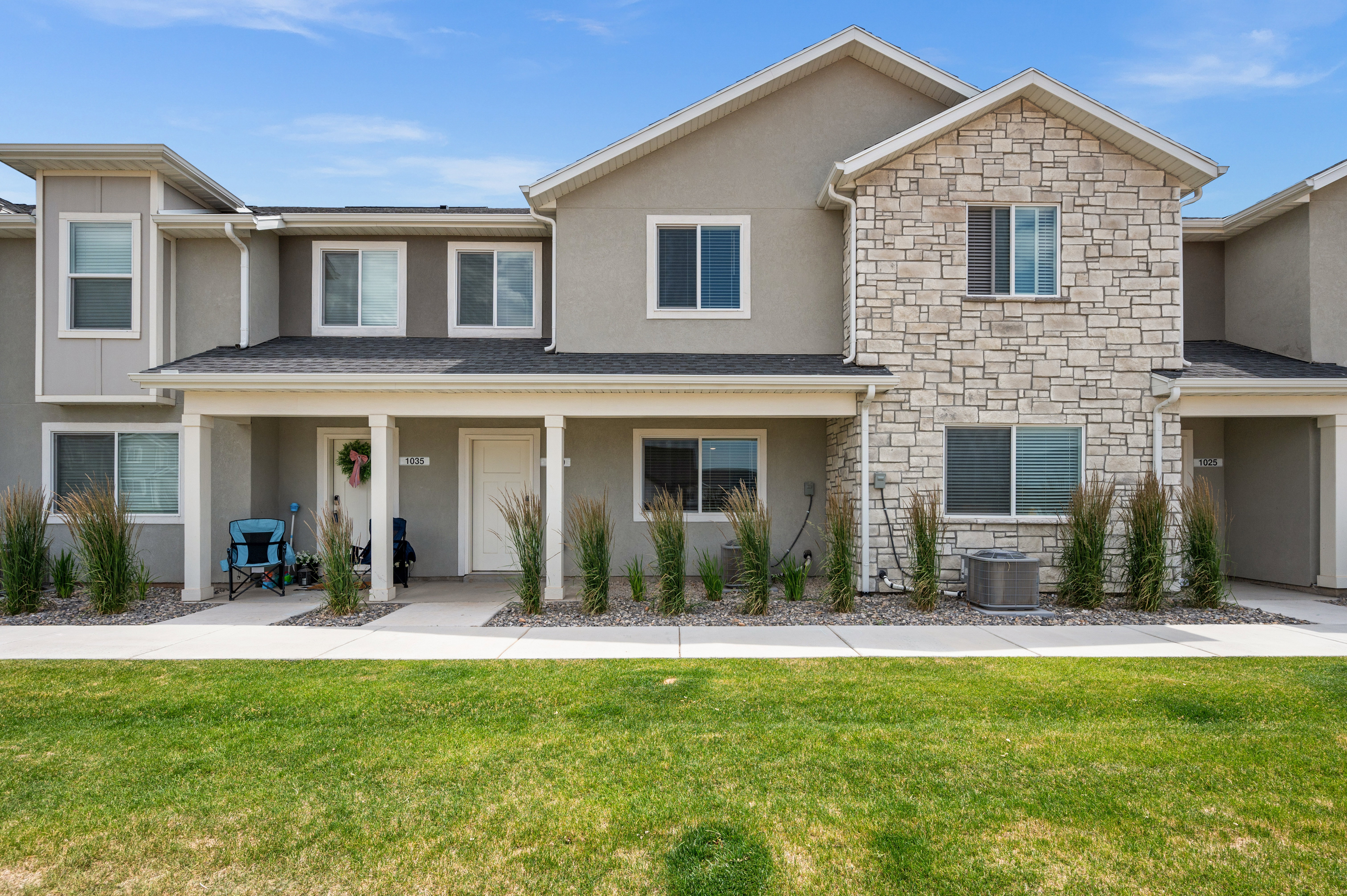 Contemporary multi-unit residence with a stone and stucco facade