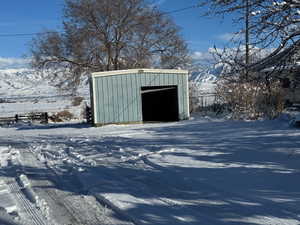 Snow covered structure featuring a mountain view