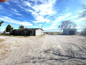 View of dirt / gravel driveway featuring a mountain view