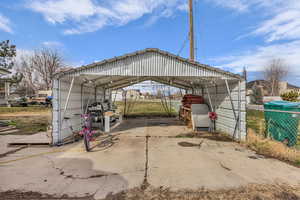 View of parking with a detached carport