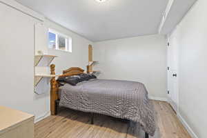 Bedroom featuring light wood-type flooring and a textured ceiling