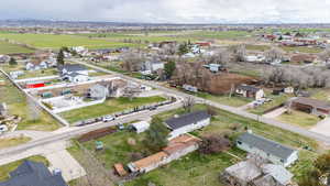 Aerial view of property and surrounding area featuring nearby suburban area