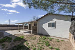 Rear view of property featuring a fenced backyard and a patio