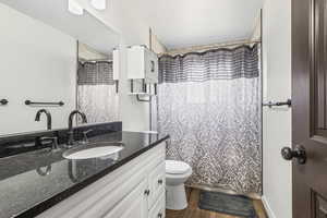 Bathroom featuring vanity and dark wood-style flooring