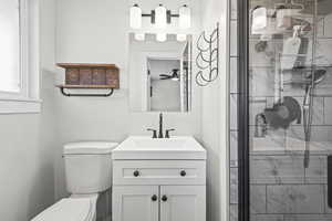Bathroom featuring a shower stall and vanity