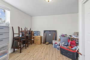 Miscellaneous room featuring light wood-style flooring and a textured ceiling