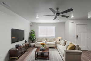 Living room with wood finished floors and a ceiling fan