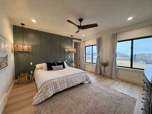 Bedroom featuring light wood finished floors, ceiling fan, and recessed lighting