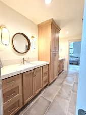 Ensuite bathroom with vanity, recessed lighting, and dark tile patterned floors