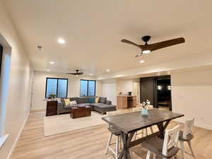 Dining area with a ceiling fan, light wood-type flooring, and recessed lighting
