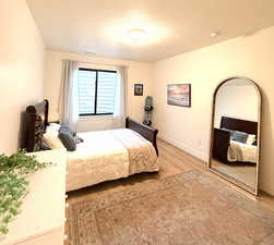 Bedroom featuring baseboards and light wood-style floors