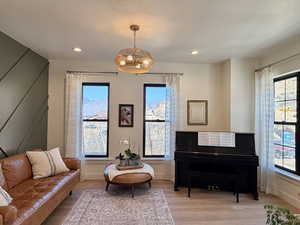 Living area featuring wood finished floors and hanging lights