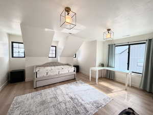 Bedroom with light wood-type flooring and multiple windows