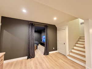 Corridor featuring light wood-style flooring and recessed lighting
