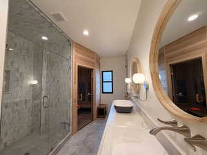Full bathroom with double vanity, a sauna / steam room, a shower stall, and recessed lighting