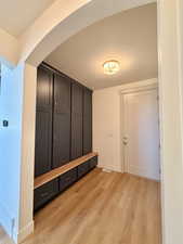 Mudroom featuring light wood-type flooring and a textured ceiling