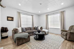 Living area featuring light wood-style floors and recessed lighting