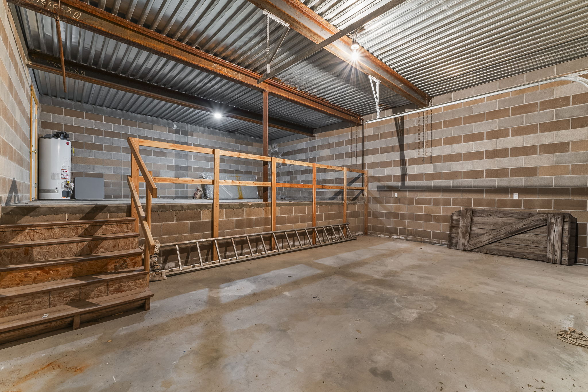 Garage with concrete block wall and gas water heater