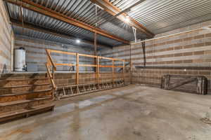Garage with concrete block wall and gas water heater