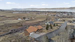 Aerial overview of property's location featuring nearby suburban area and a water and mountain view