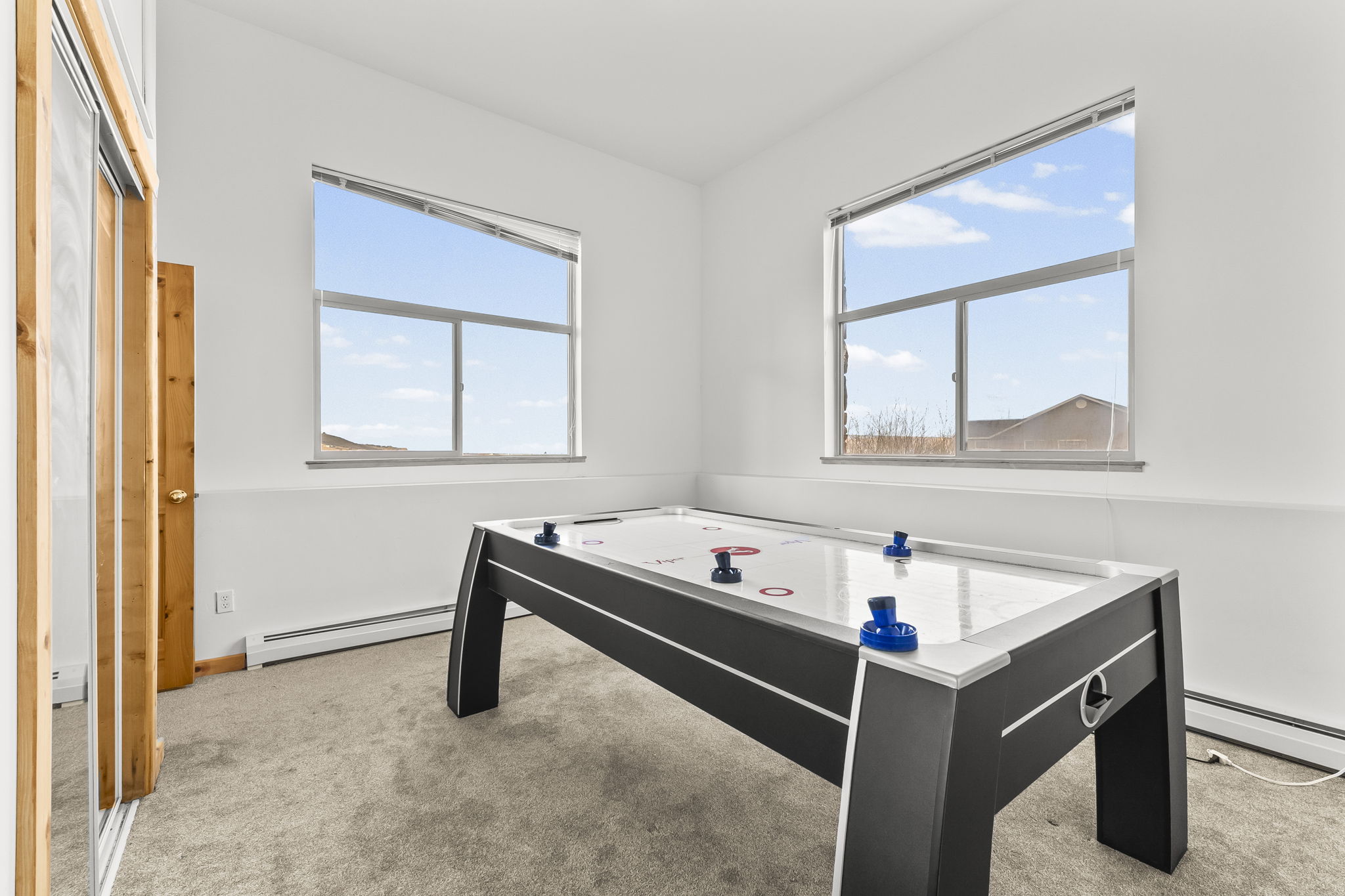 Playroom featuring light carpet and a baseboard radiator