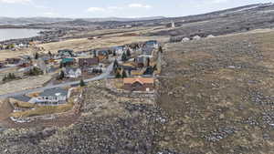 Aerial view of property's location with nearby suburban area and a mountainous background