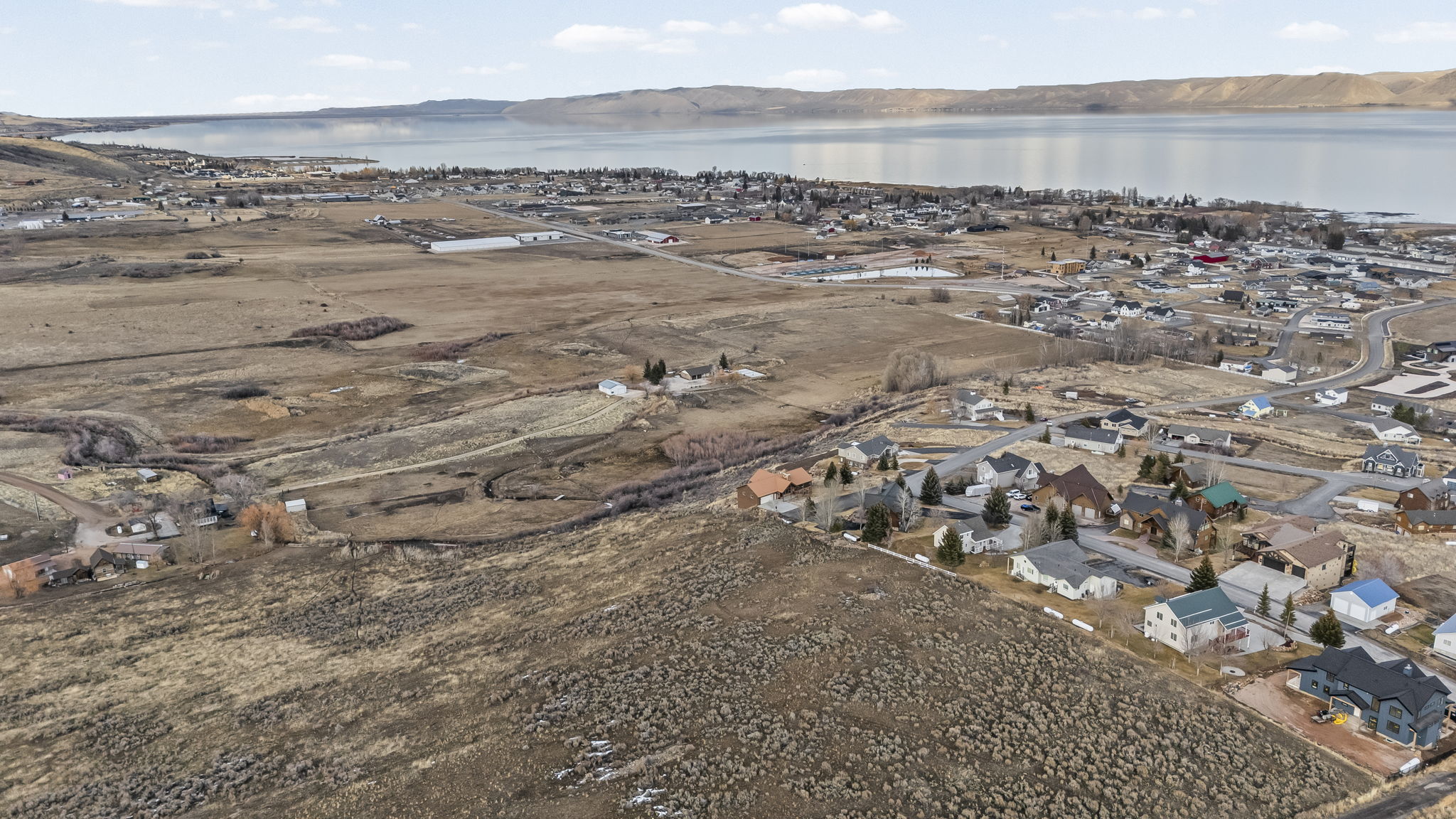 View of property location featuring nearby suburban area and a large body of water