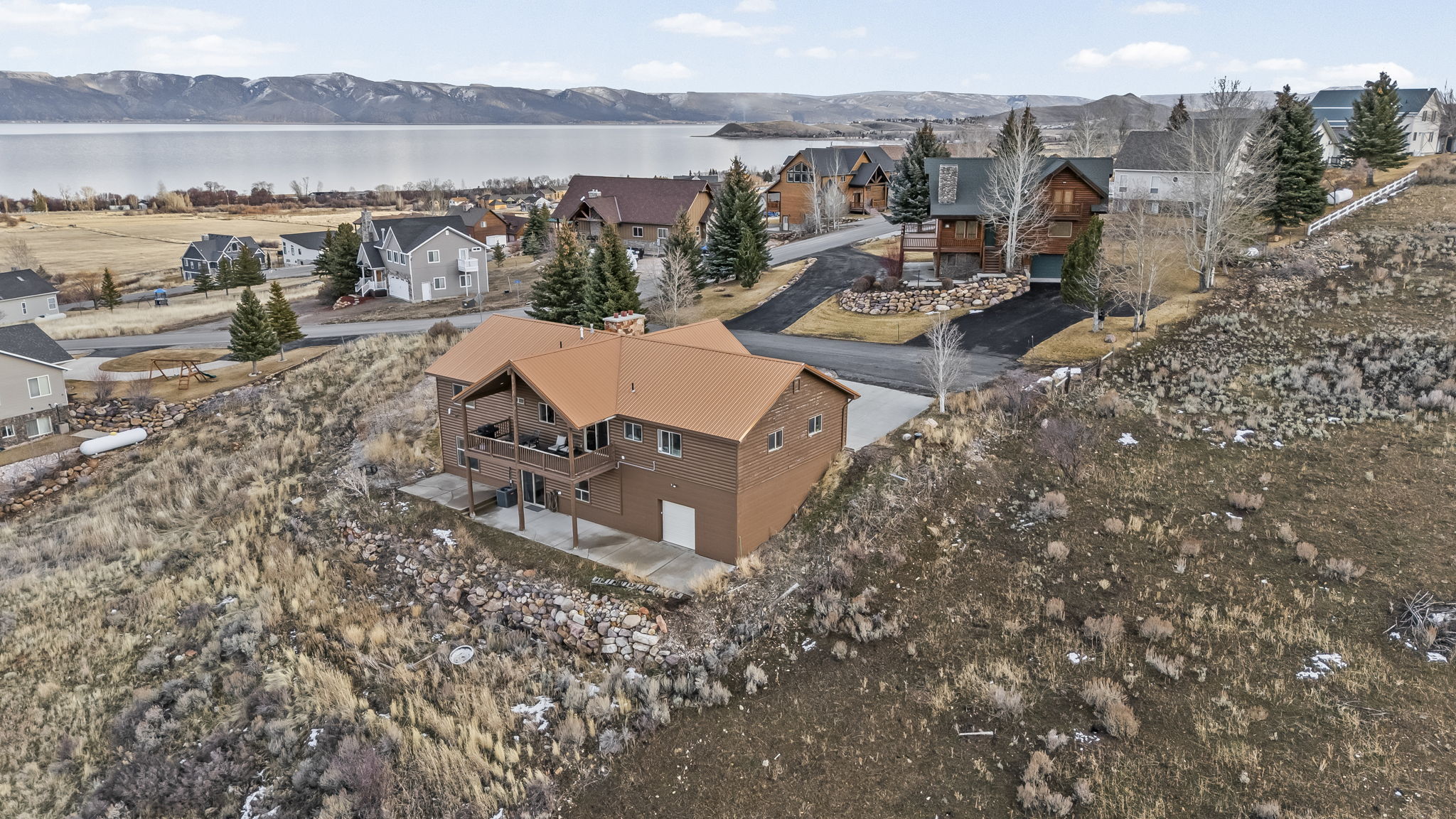 Aerial view of residential area featuring a nearby body of water