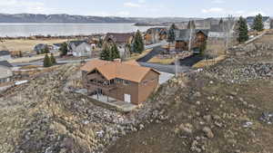 Aerial view of residential area featuring a nearby body of water