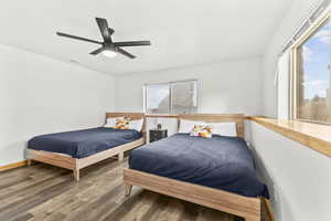 Bedroom featuring wood finished floors and a ceiling fan