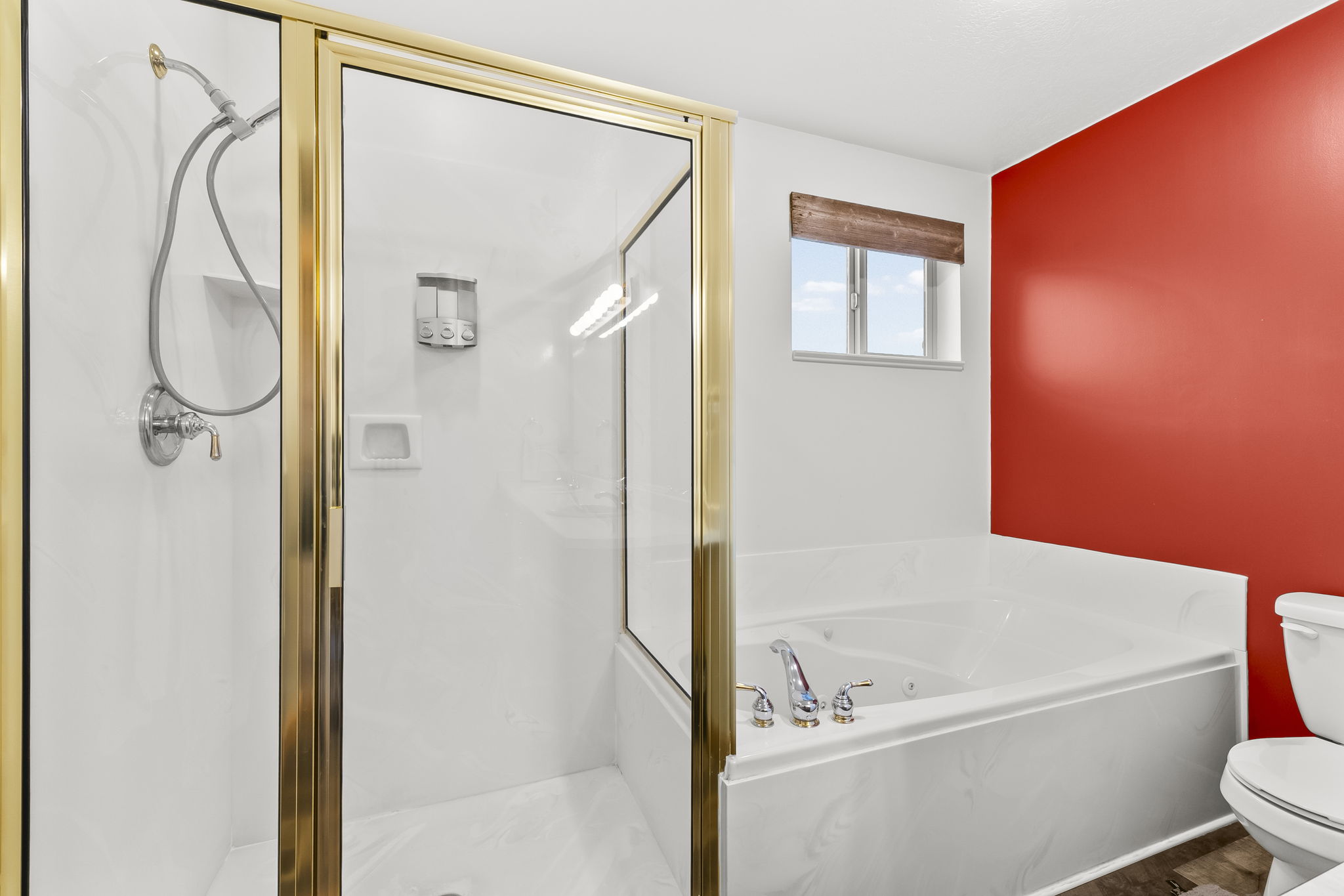 Full bath featuring a stall shower and a garden tub