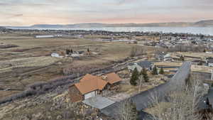 Aerial view of property's location featuring a water and mountain view and nearby suburban area