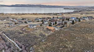 Aerial view at dusk of a residential view and a water and mountain view