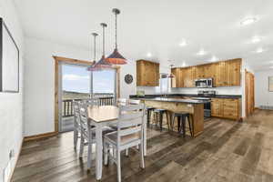 Dining room with dark wood-style floors and recessed lighting