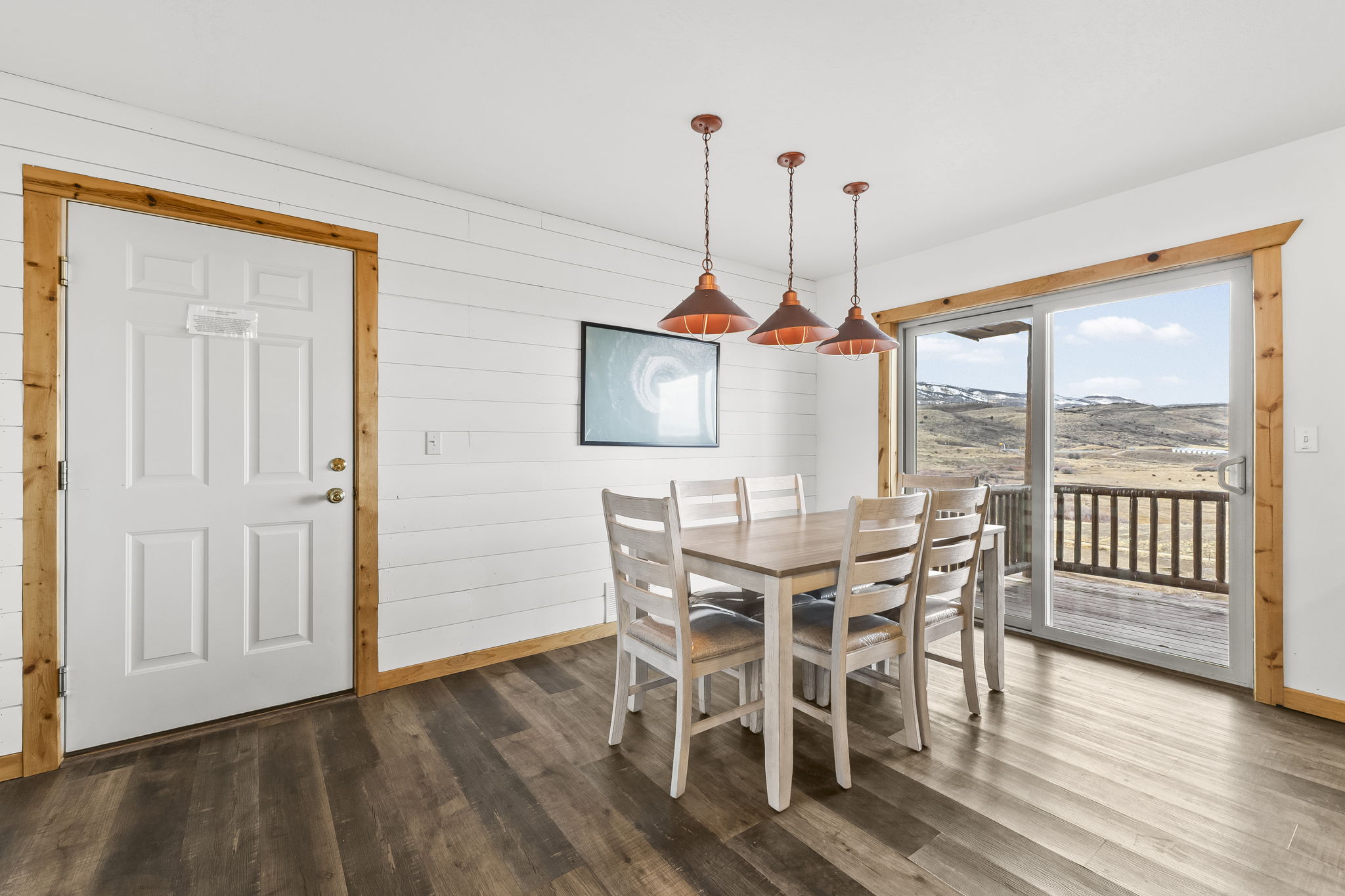 Dining room with wood walls, wood finished floors, and a mountain view