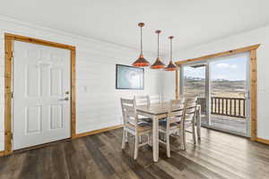 Dining room with wood walls, wood finished floors, and a mountain view
