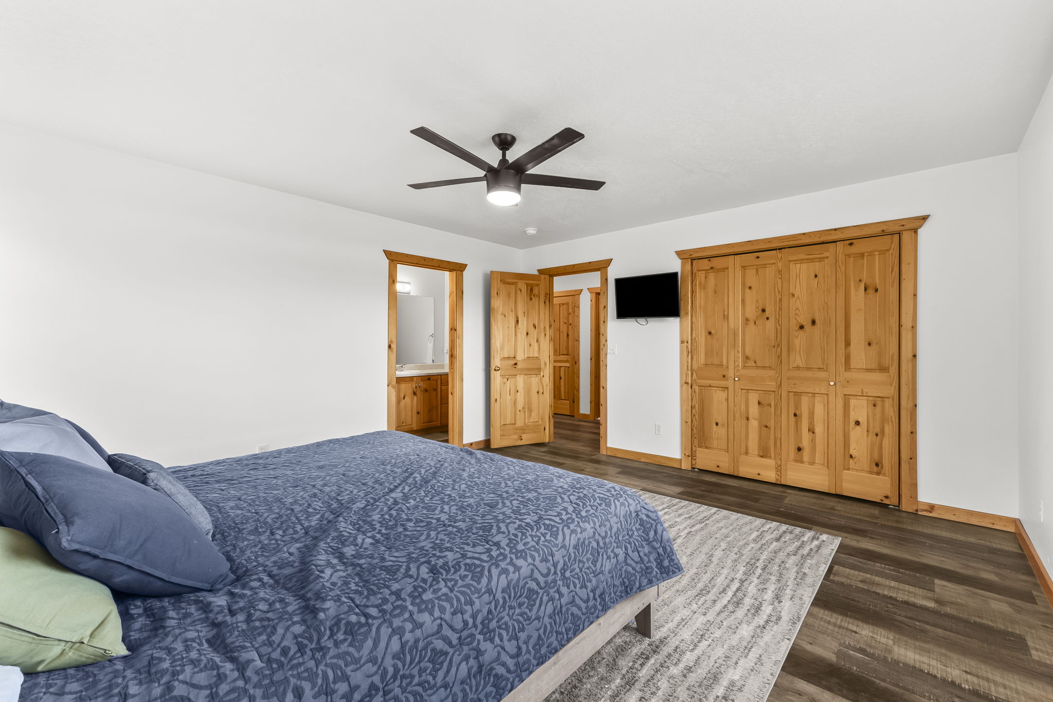 Bedroom with dark wood finished floors, ceiling fan, and a closet