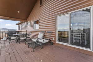Deck featuring outdoor dining area, area for grilling, and a mountain view