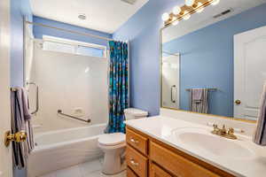 Hall bath with tile flooring, and tub/shower