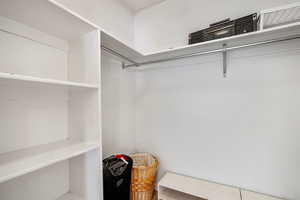 Walk in closet in primary bedroom