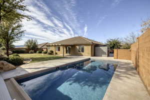 Rear view of property with a patio, a fenced backyard, a tiled roof, and stucco siding
