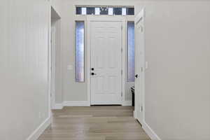 Entrance foyer featuring light wood-style floors and baseboards