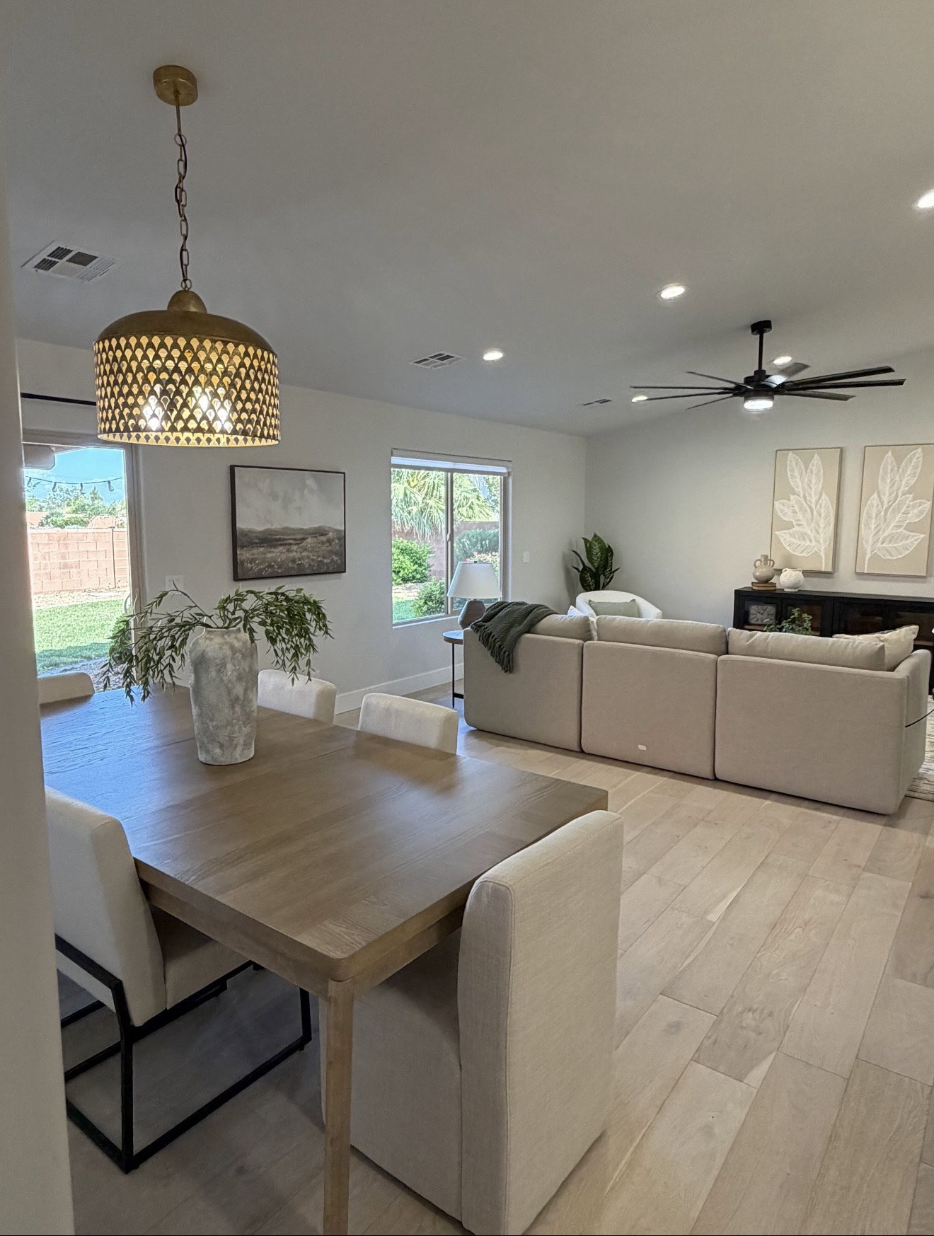 Open-concept living area featuring wood-finish flooring, recessed lighting, and a modern ceiling fan